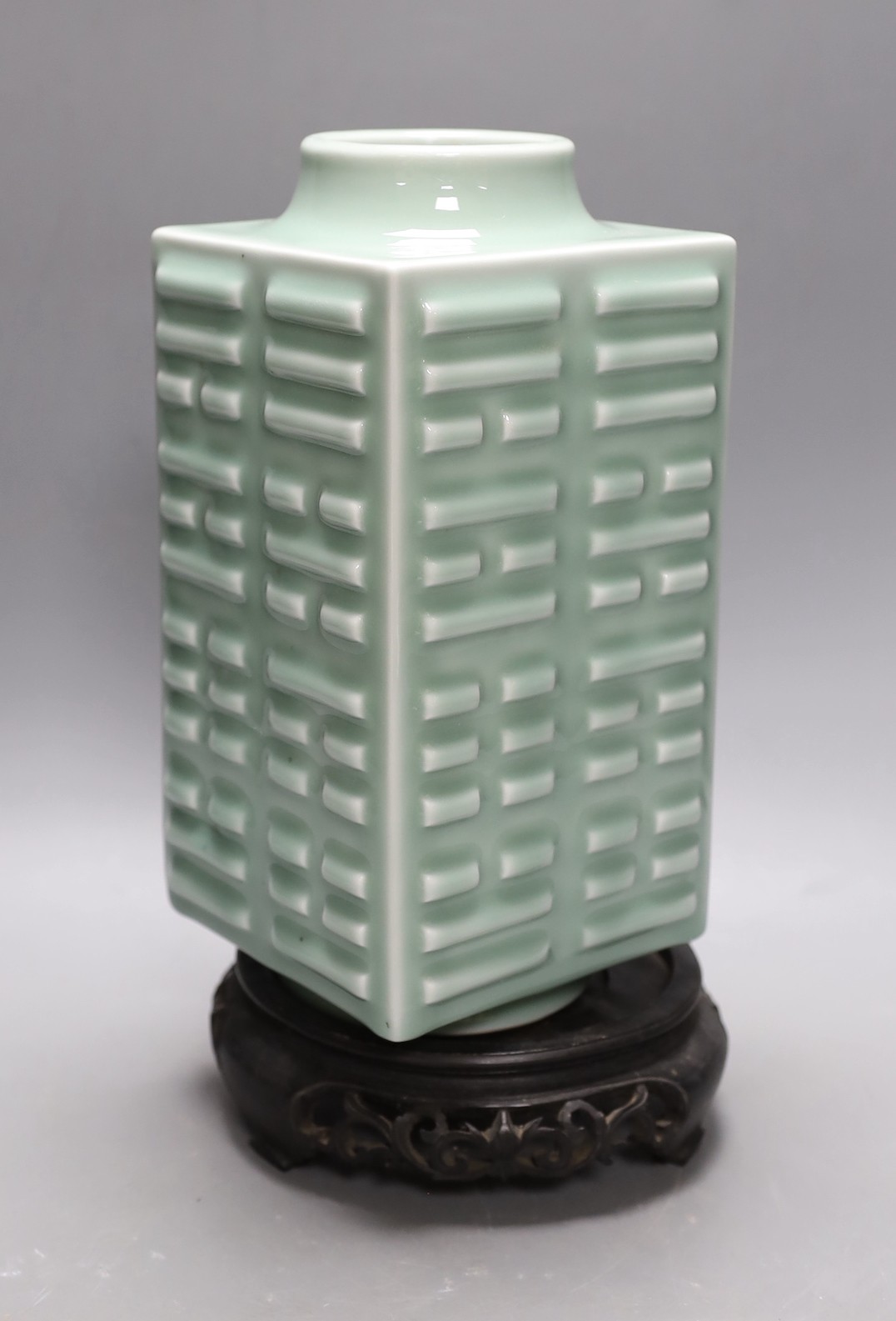 A Chinese celadon ‘eight trigrams’ vase, on stand. 32cm tall